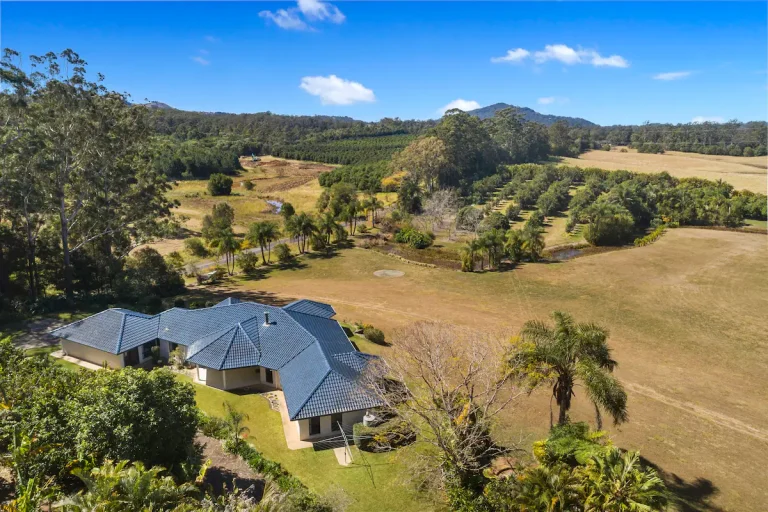 Peachester Villa from above, with the Glass House Mountains in the distance