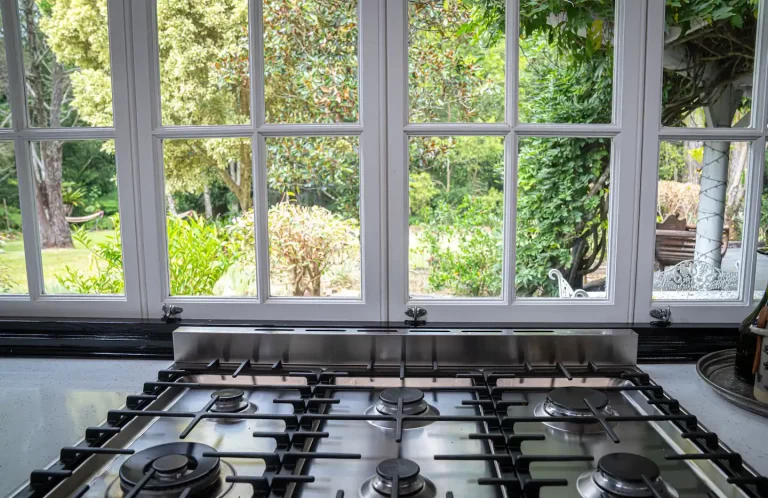 The gas cooktop under a window onto the garden