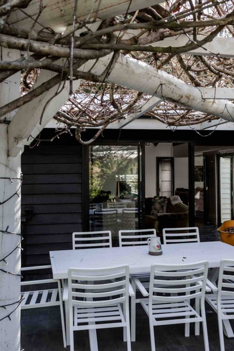 The covered alfresco dining table under the pergola