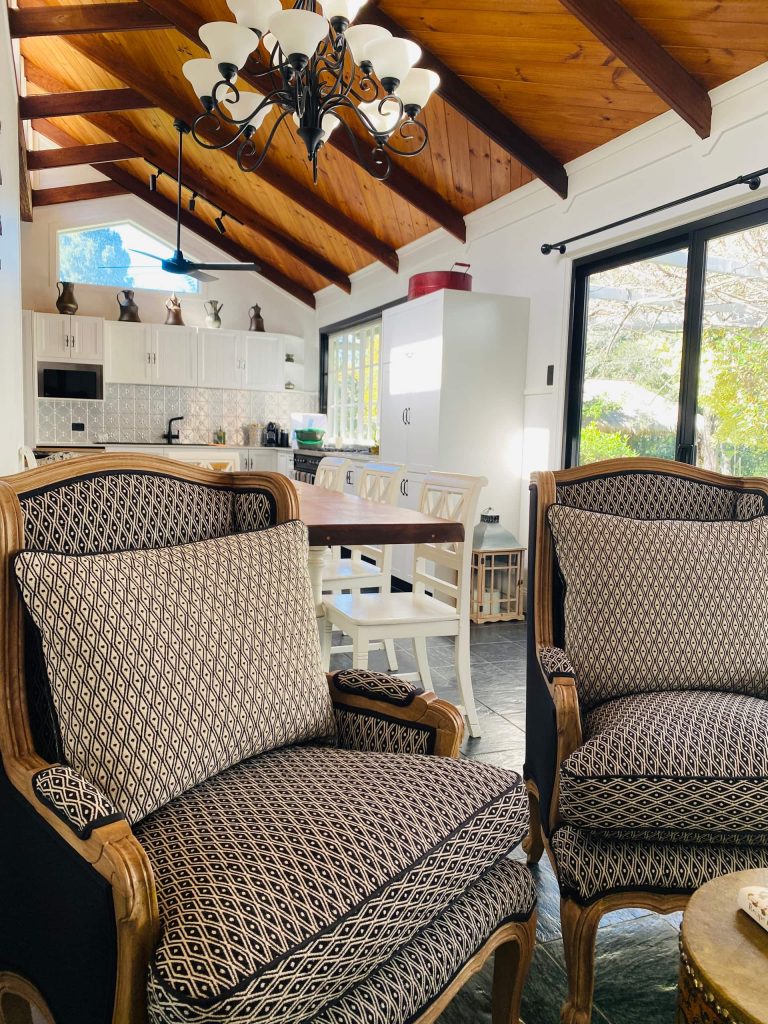 The dining room at Bahche House with rattan chairs and big windows
