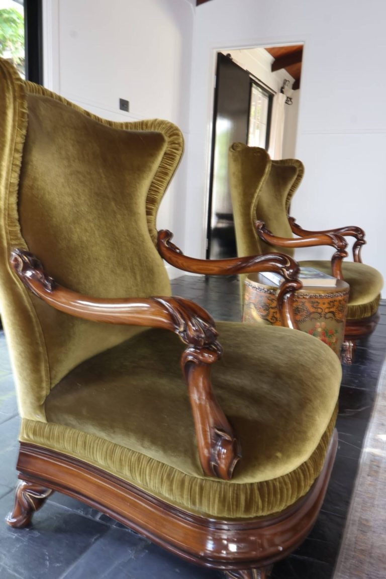 Green velvet armchairs in the second lounge at Bahche House