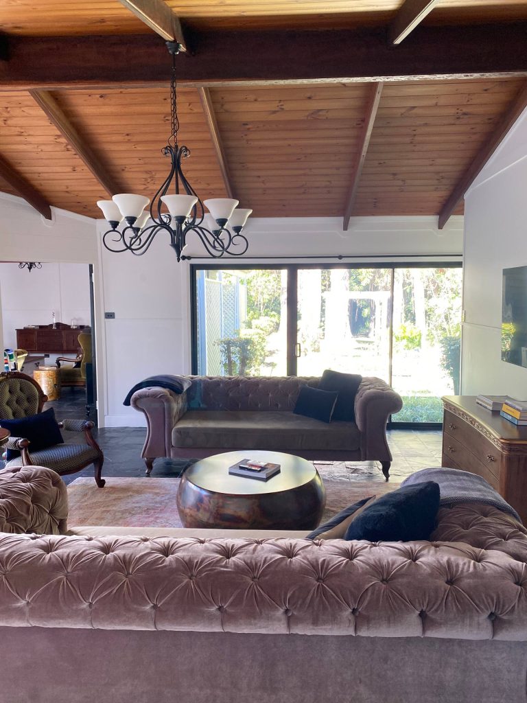 The main living room at Bahche House with velvet sofas and a chandelier